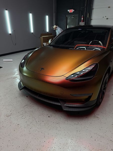 Tesla Model 3 in a gold colour-shift wrap